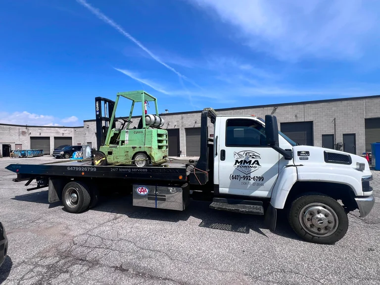 MMA Towing hauling a forklift on an equipment move